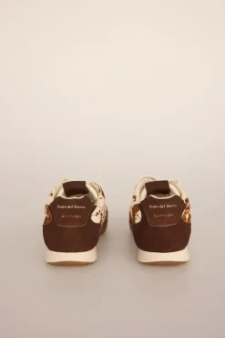 Zapatillas de piel con estampado vaca
